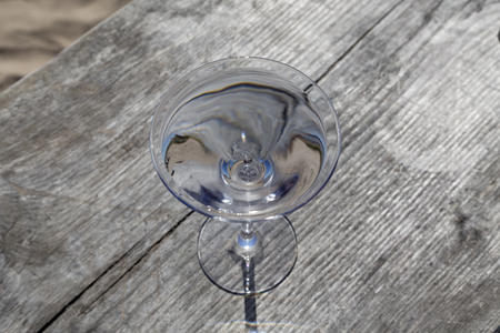 A glass with water on a table of wood in the backgroundの写真素材