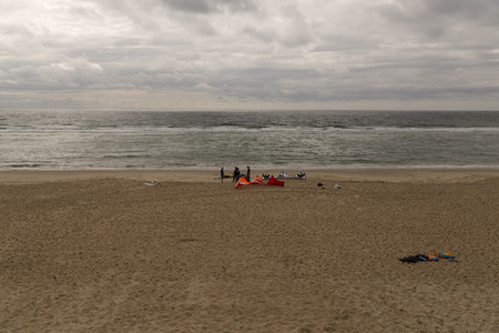 A group of parakiters on a beach in Franceのeditorial素材