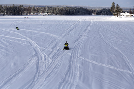 A group of snow mobiles on the iceの写真素材