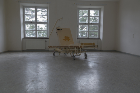 An old empty hospital bed with a naked mattresの写真素材