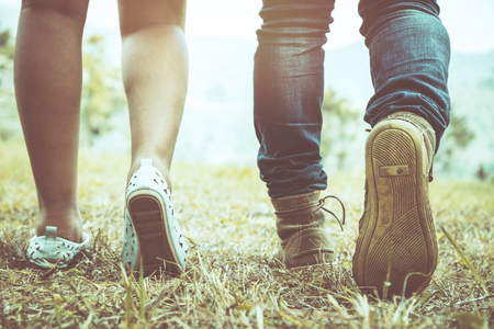 Men's legs with women walking together on vacation.の写真素材