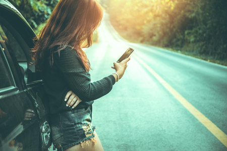Mobile Phone Woman The car is broken on the road.の写真素材
