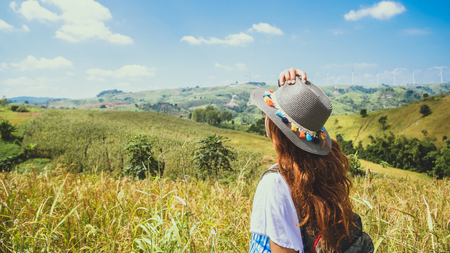 Asian women travel relax in the holiday. Stand natural touch mountain field. Thailandの写真素材