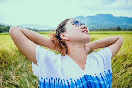 Asian women travel relax in the holiday. Stand natural touch mountain field. Thailandの写真素材