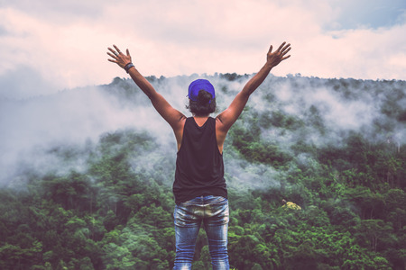 Asian man travel relax in the holiday. Wild nature wood on the mountain. 