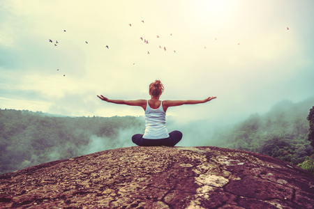 Asian women relax in the holiday. Play if yoga, natural caves, forests, mountains and mist.の写真素材