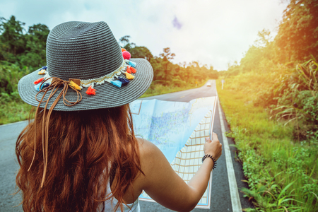 Asian women travel relax in the holiday. Take a look at the map on a rural road in the middle of nature. Thailandの写真素材