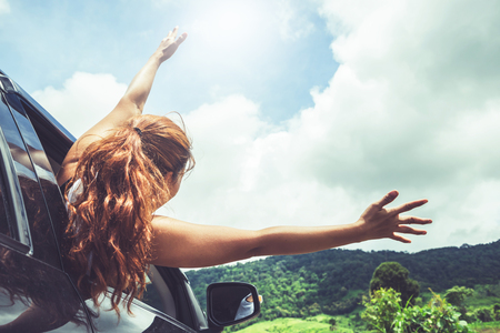 Asian women travel relax in the holiday. driving a car traveling happily.の写真素材