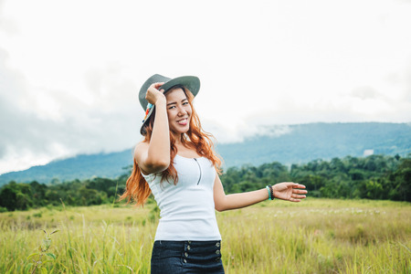 Asian women travel relax in the holiday. on a green pasture.の写真素材