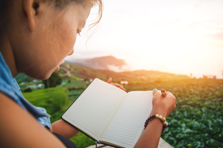 Read women relax in the park.Write the record. Morning atmosphere The mountains are foggy. thailandの写真素材