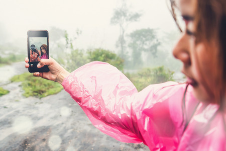 Lover Men and women Asia travel relax. walk in the forestrainy season. photograph couple....