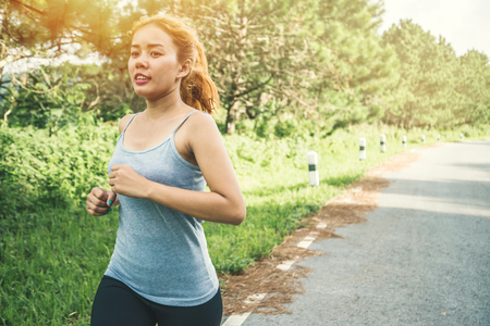 Women exercise on the street. Nature park. Asian womenの写真素材