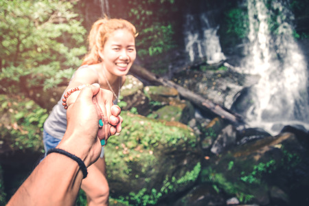 Male and woman couples asia. Walking hand travelers travel nature Forests, mountains, waterfalls....