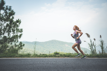 Women jogging On the nature trail in the parkの写真素材