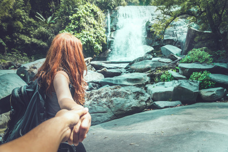 Male and woman couples asia. Walking hand travelers travel nature Forests, mountains, waterfalls