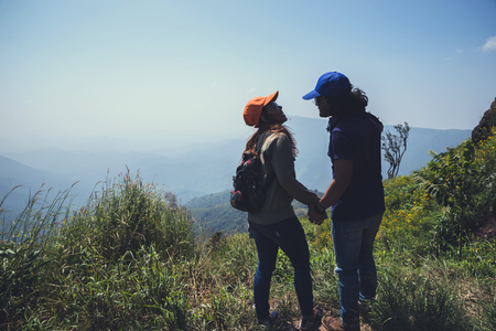 Lover women and men asians travel relax in the holiday. Stand up landscape on the Moutain. Mountain Park happily. In Thailandの写真素材