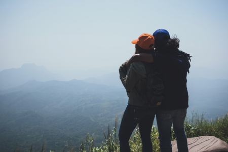 Lover women and men asians travel relax in the holiday. Stand up landscape on the Moutain. Mountain Park happily. In Thailandの写真素材