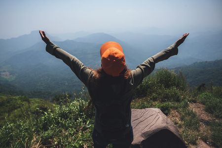 Asian women travel relax in the holiday.  Stand and watch landscape on the Moutain. Mountain Park happily. In Thailandの写真素材