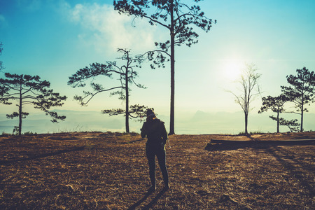 Asian women travel relax in the holiday. Watching Sunrise in the morning. In the winter. In Thailandの写真素材