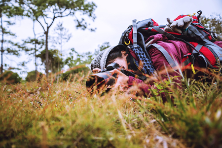 Photographer asian women Traveling photograph Nature. travel relax in the holiday walk in the forest. travel relax in the holiday.  Thailandの写真素材