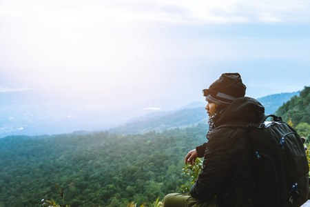 Men asians travel relax in the holiday. Admire the atmosphere landscape on the Moutain. Mountain Park happily. In Thailandの写真素材