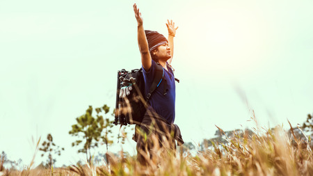 Asian men travel  nature. Travel relax.Backpack walk on the meadow in the forest. Thailandの写真素材