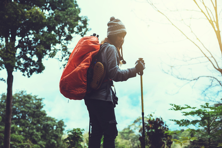 Asian woman travel  nature. Travel relax. Backpack walk in the forest. Thailandの写真素材