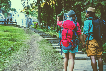 Lover woman and men Asian travel nature. Travel relax. Natural Touch countryside. On the Moutain. At Waterfall Use summer.  Thailandの写真素材