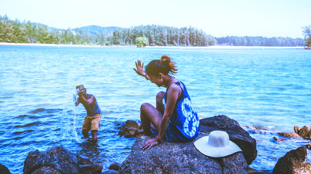 Asian lover woman and man travel nature. Travel relax. Play sea water on the beach. In the summer....