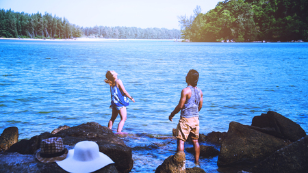 Asian lover woman and man travel nature. Travel relax. Play sea water on the beach. In the summer....