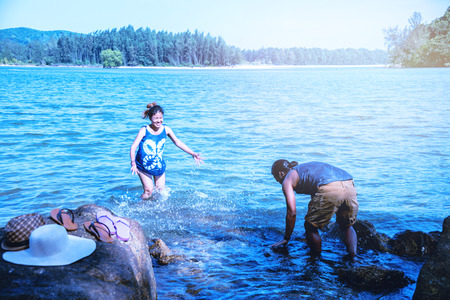 Asian lover woman and man travel nature. Travel relax. Play sea water on the beach. In the summer....
