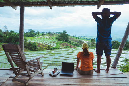 Lover woman and man Asian travel nature. Travel relax. The balcony of the resort. View of the field on the Moutain in summer. Thailandの写真素材