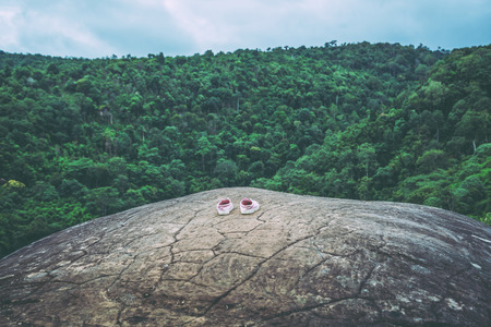 Travel Asia holiday. landscape on the rock cliff, the shoes are on a rocky cliff.の写真素材