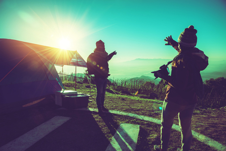 Lover women and men asians travel relax camping in the holiday. On the Moutain. Taking photos at sunrise. Thailandの写真素材
