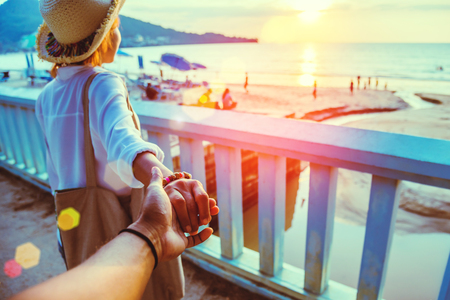Asian lovers happy and be smile holding hands. Travel beach summer vacation.の写真素材