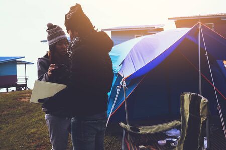 Lover women and men asians travel relax camping in the holiday. Camping In the winter.Read books, drink coffee. Thailandの写真素材