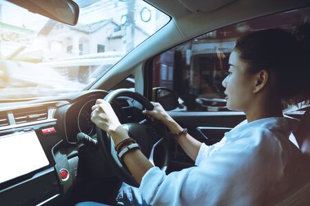 Woman hand holding the steering wheel a car. drive a car travel relax in the holiday. Driving skills...