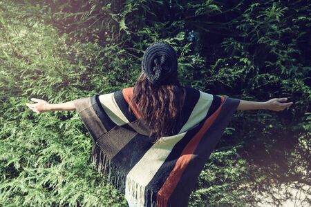 Young woman relax in the holiday she smiling happy Enjoy the beauty of the pine leaves.