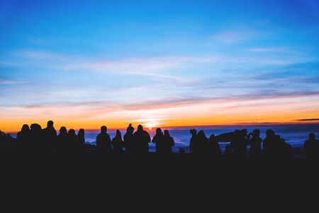 People travel nature. Travel relax. background silhouette People watching Sunrise and photographing the sea of ââfog on the mountain.の写真素材