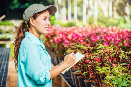 The girl are studying and Save the change of trees, flowers Beautiful (garden flower) background in nature farmersの写真素材