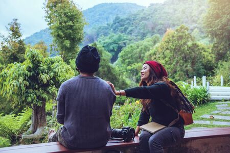 Asian couple travel photograph nature education. nature relax and study read a book. at public park. In Thailandの写真素材