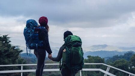 Asian couples travel nature on the mountains in winter.Travel relax. Natural touch countryside at...