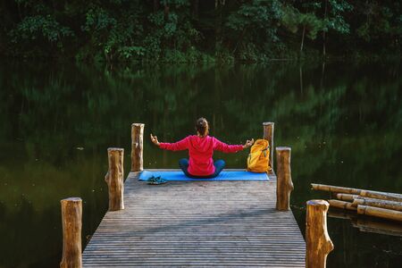 Asian women relax in the holiday. Play if yoga. On the Moutain,Exercise,Play if yoga on the Bamboo...