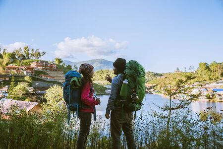 Lover women and men asians travel relax in the holiday. Stand up looking landscape on the mountains....