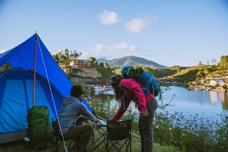 Couple Enjoying Camping Holiday In Countryside.Camp in the mountains near of the lake.の写真素材