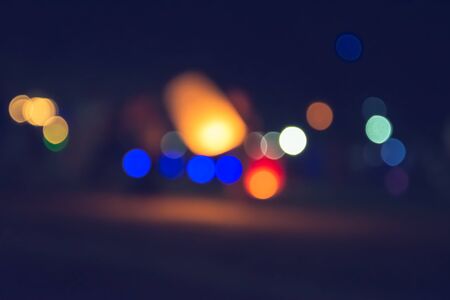 Vintage tone abstract blur image at night with bokeh for background use. Bokeh light and background blurred.の写真素材