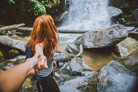 Male and woman couples asia. Walking hand travelers travel nature Forests, mountains, waterfalls. Travel Siliphum Waterfall at Chiangmai, in  Thailand.の写真素材