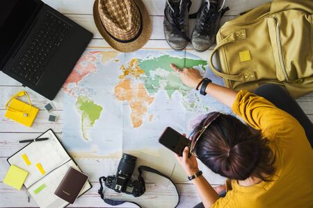 Vacation travel planning concept with map. Overhead view of equipment for travelers. Travel concept...