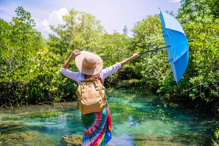 A young traveler girl relax in the holiday enjoying the beauty of nature lake mangrove forest at tha pom-klong-song-nam at krabi. summer, Travel, Thailand, freedom, Attractions.の写真素材