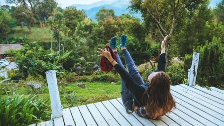 Woman natural tourist on the mountain, she is sitting relax reading books in the midst of nature on...